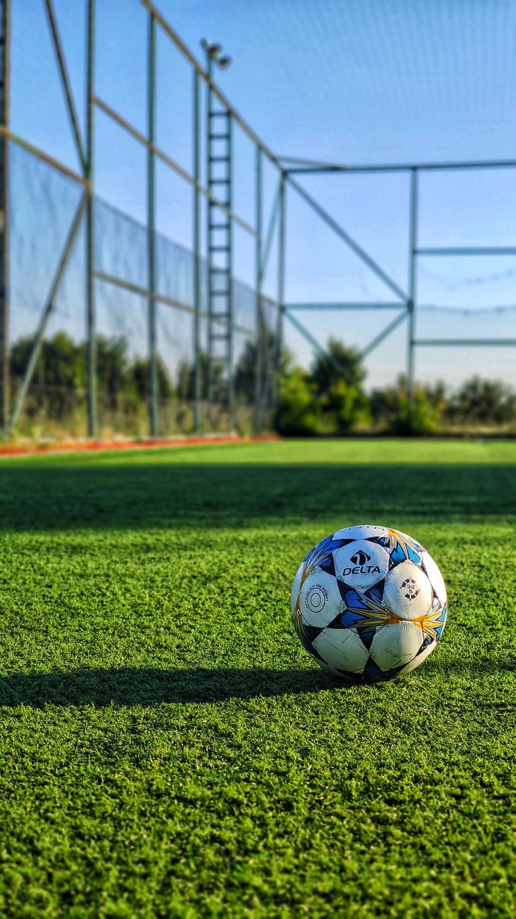 Vibrant photo of a soccer ball on an outdoor field in Istanbul, Turkey.